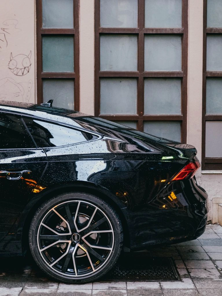 A chauffeured arrival at the stone porte-cochère of a Cap-Ferrat villa at dusk.