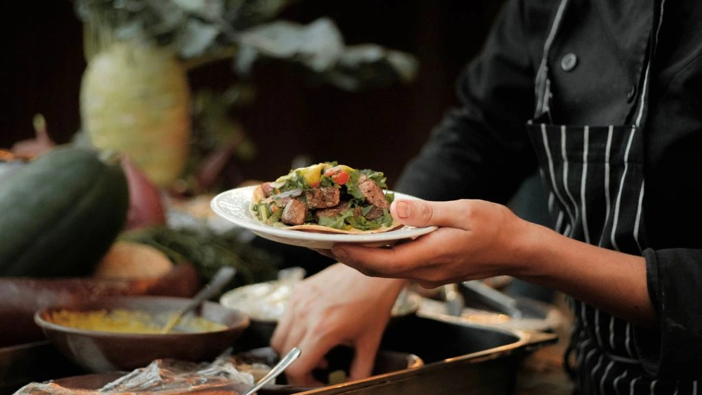 A private chef plating the closing-night tasting menu